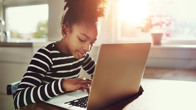 Photo of a student working on a laptop computer