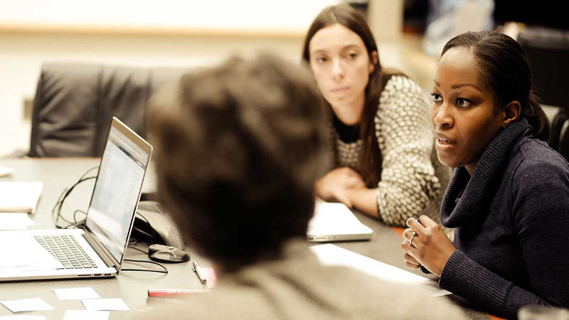 Photo of three people in discussion