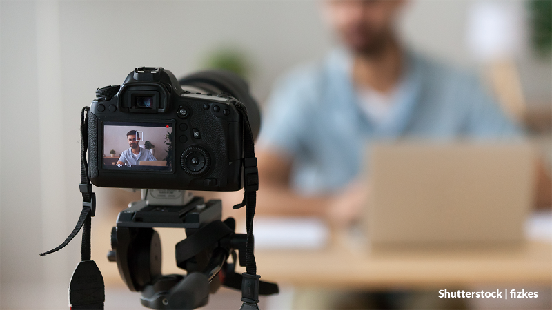 Photo of an educator recording themselves with a video camera